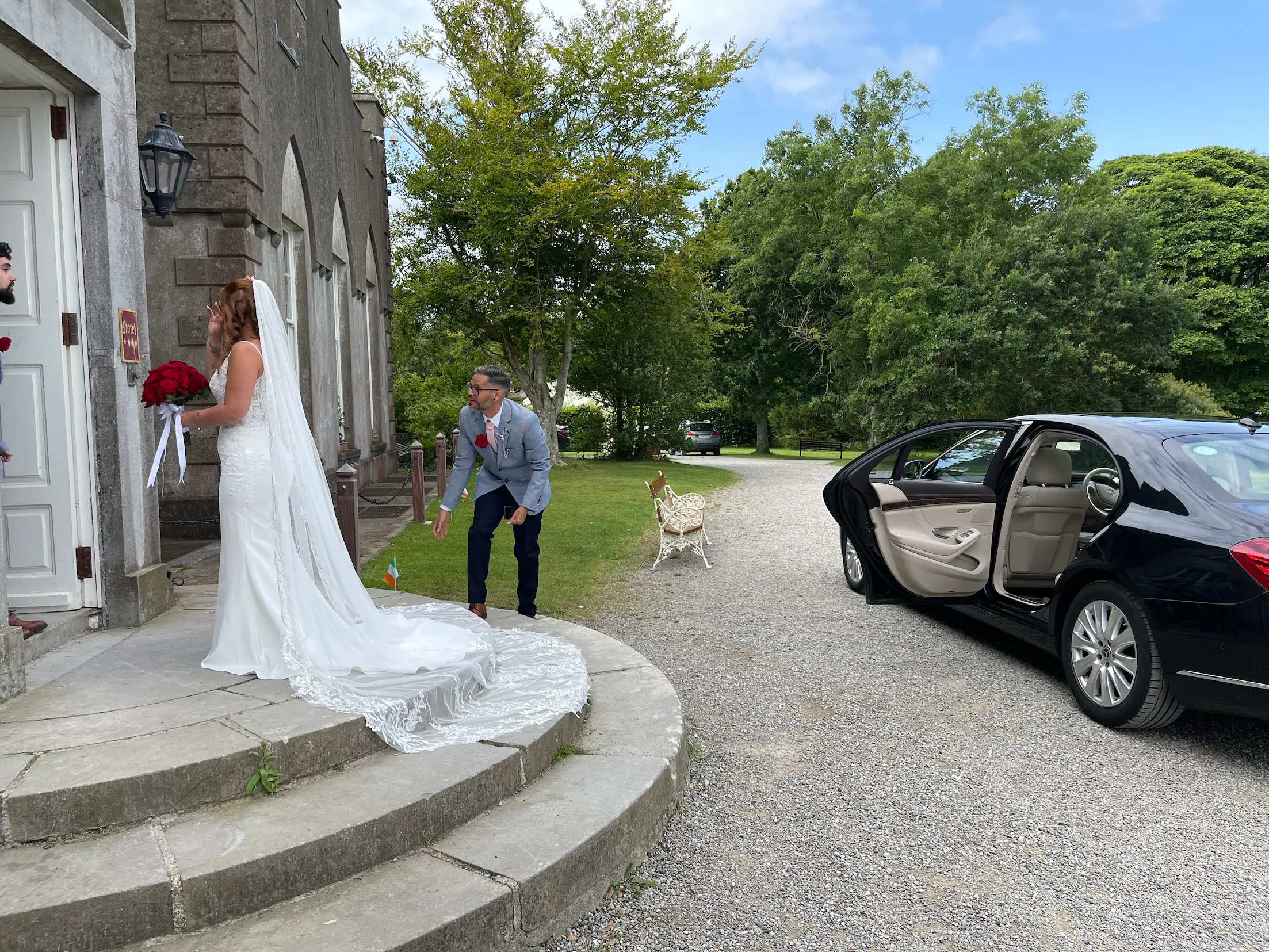 Bride and groom beside Mercedes S-Class